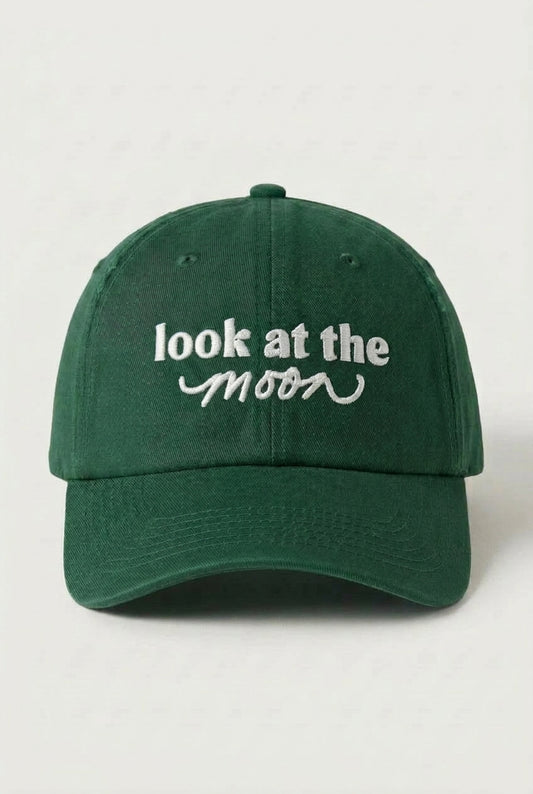 Green cap with 'look at the moon' text on a white background
