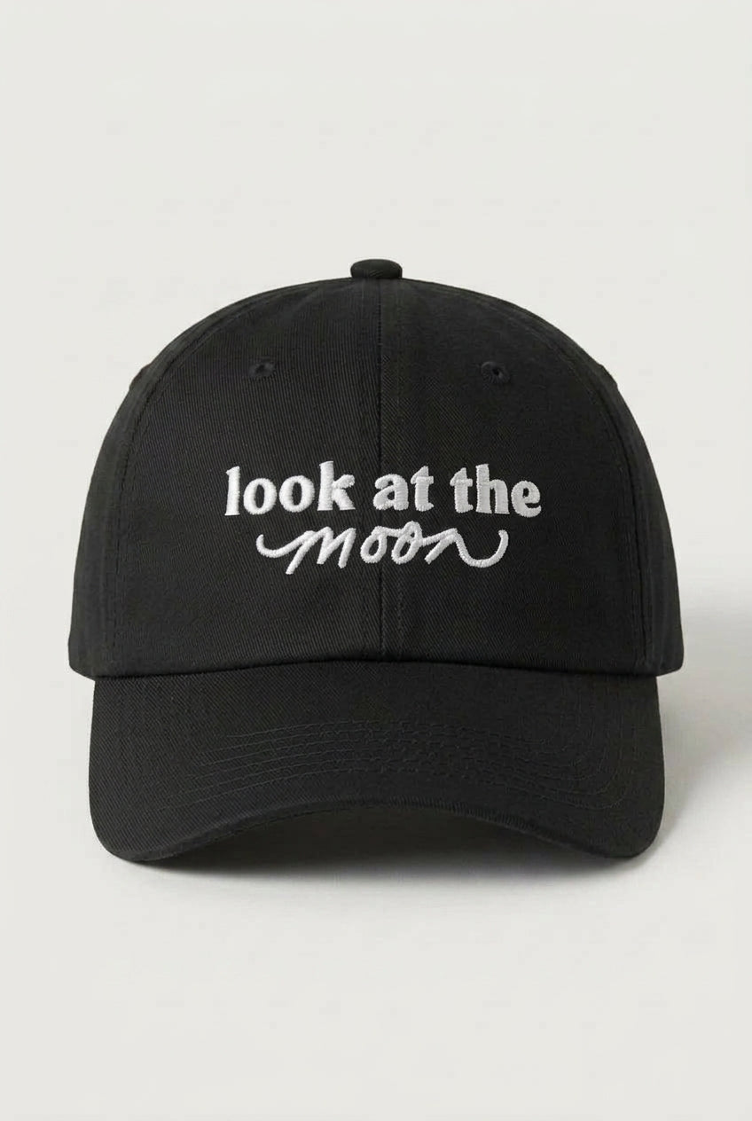 Black cap with 'look at the moon' text on a white background