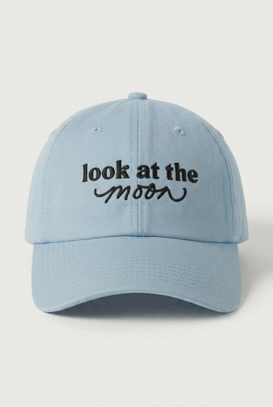Light blue cap with 'look at the moon' text on a light gray background
